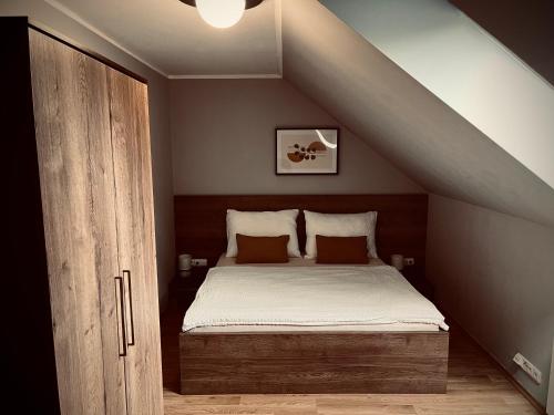 a bedroom with a bed in the attic at Penzion Prestige Tennis Park in Frýdek-Místek
