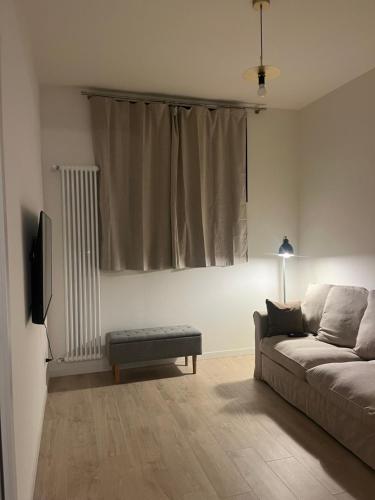 a living room with a couch and a tv at AL 31 Bg in Bergamo
