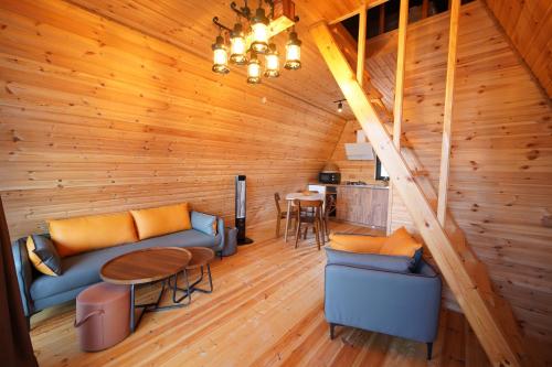 a living room with a couch and a table at A Little Paradise in Batumi