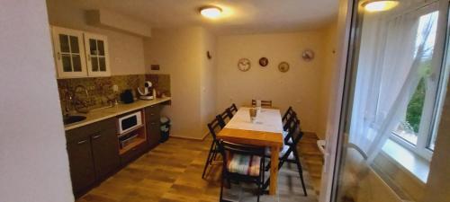 a kitchen with a table and chairs in a room at Къща за гости DANI DREAM in Sapareva Banya