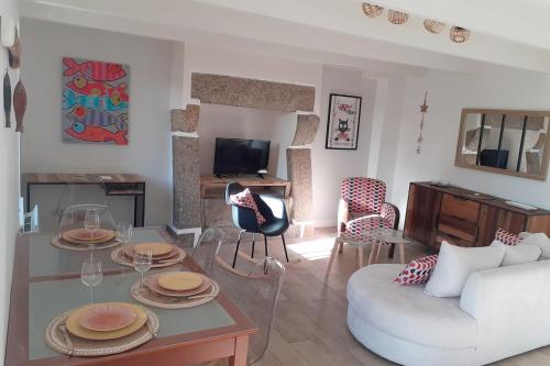 a living room with a white couch and a table at "Ty Nonod" Quiet Breton farmhouse 500m from the sea in Lampaul-Plouarzel in Lampaul-Plouarzel