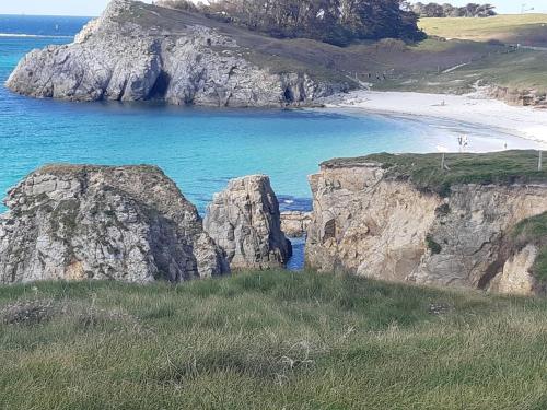 a beach with two large rocks in the ocean at "Ty Nonod" Quiet Breton farmhouse 500m from the sea in Lampaul-Plouarzel in Lampaul-Plouarzel
