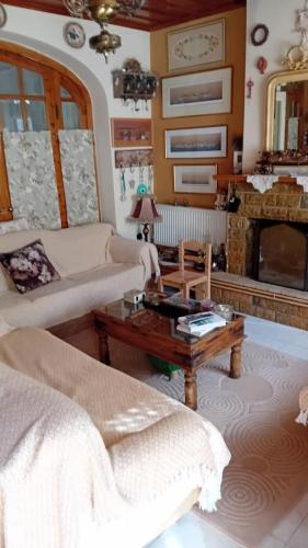 a living room with a couch and a fireplace at Areti's Captain's House with Private Terrace in Galaxidhion
