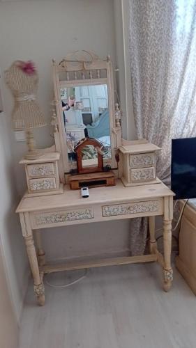 a dressing table with a mirror on top of it at Areti's Captain's House with Private Terrace in Galaxidhion