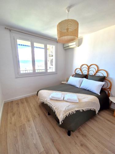 une chambre avec un lit avec deux serviettes dessus dans l'établissement Appartement Ajaccio vue mer, à Ajaccio
