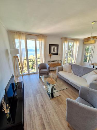 een woonkamer met een bank en een tv bij Appartement Ajaccio vue mer in Ajaccio