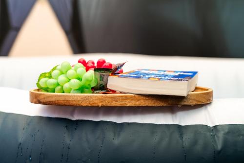 a plate of fruit and a book on a table at Open Mind Property - HotTub, 7 Guests & Parking in Portsmouth