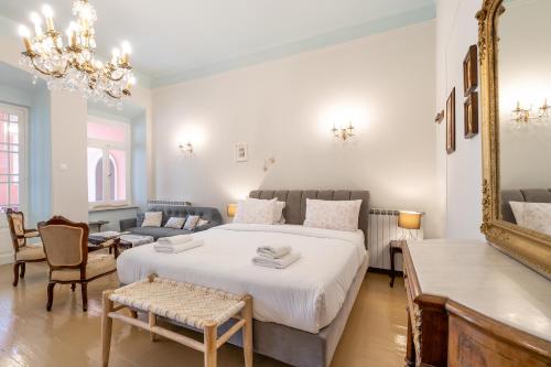 a bedroom with a large bed and a living room at Neoclassical Mansion in Andros Town by Explore Andros in Andros