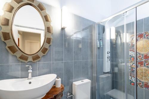 a bathroom with a sink and a mirror at Neoclassical Mansion in Andros Town by Explore Andros in Andros