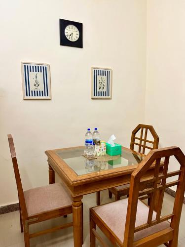 a table with two chairs and two bottles of water on it at The Mango Tree by ANAND VILLA in Jodhpur