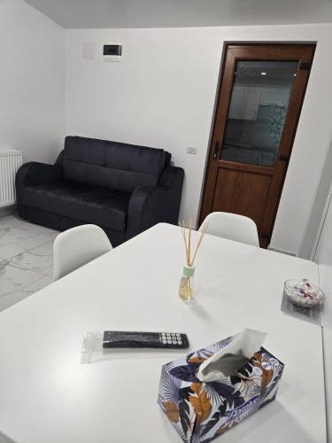 a white table with a remote control on top of it at Casa M&V in Focşani