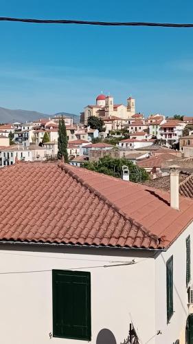 a view of a white building with a red roof at Areti's Captain's House with Private Terrace in Galaxidhion