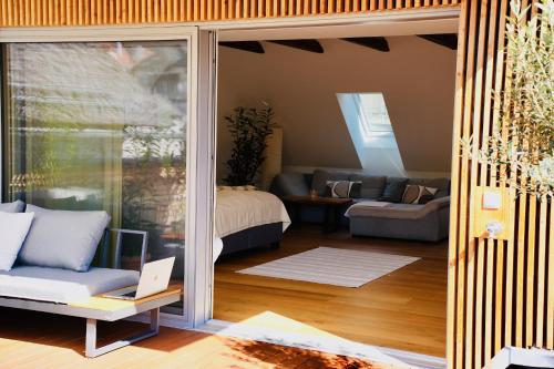 a living room with a couch and a table at Exklusive Dachgeschoß-Suite mit Sauna & Terrasse in Waidhofen an der Ybbs