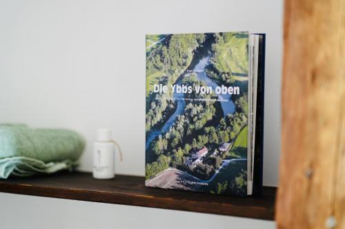 a book sitting on top of a wooden shelf at Exklusive Dachgeschoß-Suite mit Sauna & Terrasse in Waidhofen an der Ybbs