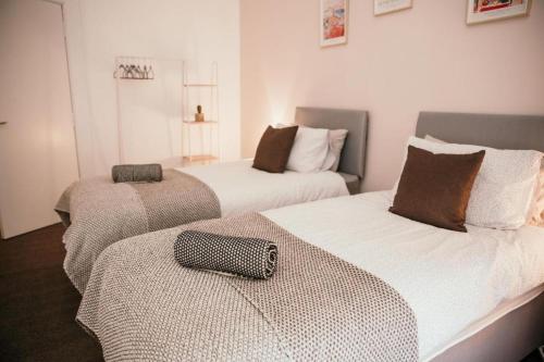 a room with two beds and a bag on the bed at Unique City Townhouse - Modern & Central Location in Belfast