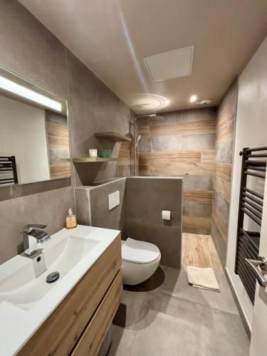 une salle de bain avec un lavabo blanc et des toilettes dans l'établissement Appartement 2p à 200m du village et 2,5km de la mer, à Villeneuve-Loubet