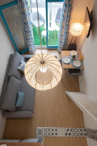 an overhead view of a living room with a chandelier at Studio au cœur des Sables d'Olonne ! in Les Sables-dʼOlonne