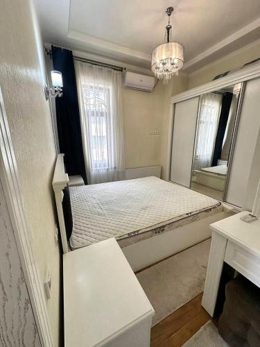 a bedroom with a large bed with a mirror at Family House in Stantsiya Kyzyl-Tukumachi