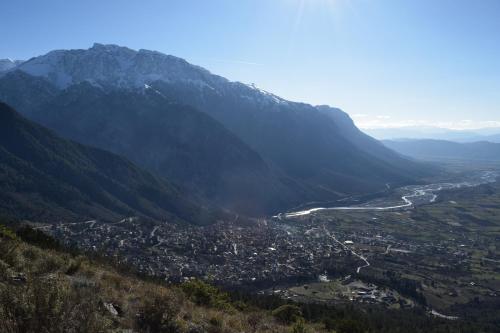 a view of a town in a valley in the mountains at Potamolithos Suites 2 in Konitsa