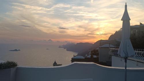 a view of the ocean at sunset from a building at Villa Antica Macina in Positano