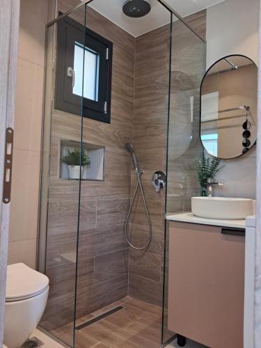 a bathroom with a shower and a toilet and a sink at The Boho Breeze Studio in Kos Town