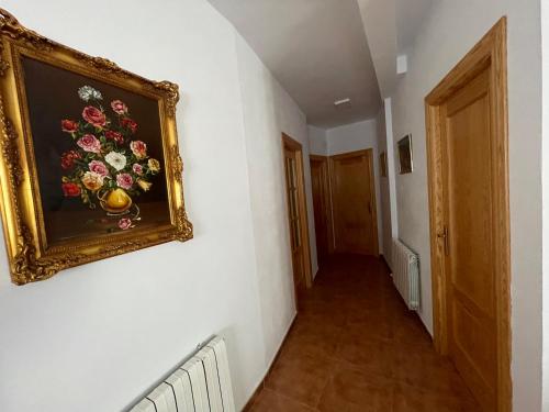 a hallway with a painting of flowers on the wall at Zuchar in Granada