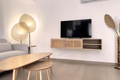 a living room with a tv on a wall at Complejo Turístico El Oasis de San José in San José