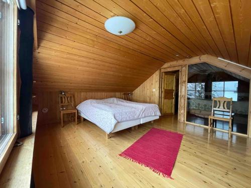 a bedroom with a bed in a room with a wooden ceiling at Idyllic house in beautiful area in Saxby
