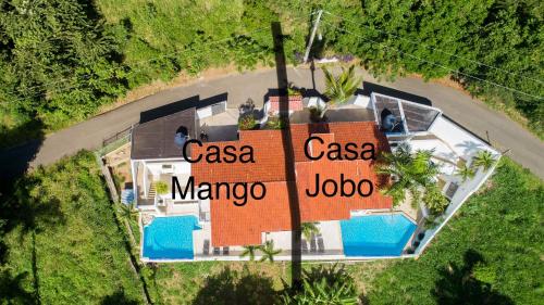 an overhead view of a house with a sign on it at Mango y Jobo - Relaxed Mountain & Sea Panoramic view - 10mins drive to beach and city in San Felipe de Puerto Plata