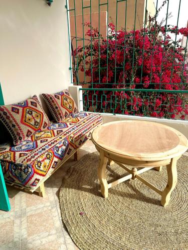 a living room with a coffee table and a couch at Dar Al-Andalus in Tamraght Ouzdar