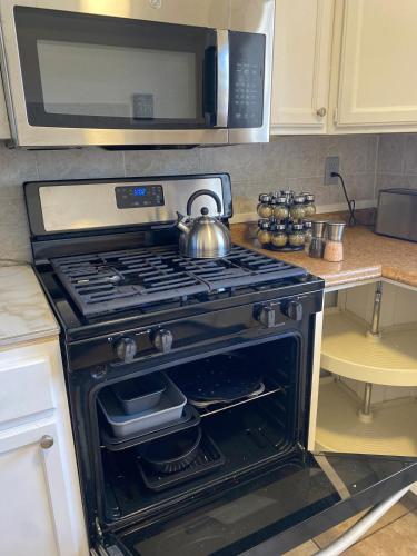 a kitchen with a stove with a tea kettle on it at Vegas Oasis- Modern Getaway 5 mins from Strip in Las Vegas