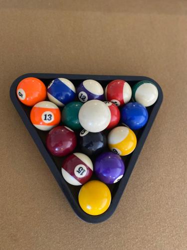 a tray of billiard balls sitting on a table at Vegas Oasis- Modern Getaway 5 mins from Strip in Las Vegas