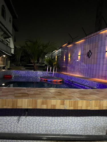 a swimming pool at night with purple lights at Apex guest facility in Buea