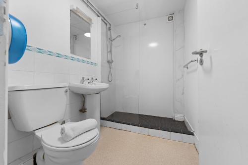 a bathroom with a toilet and a sink and a shower at Glendalough International Youth Hostel in Laragh