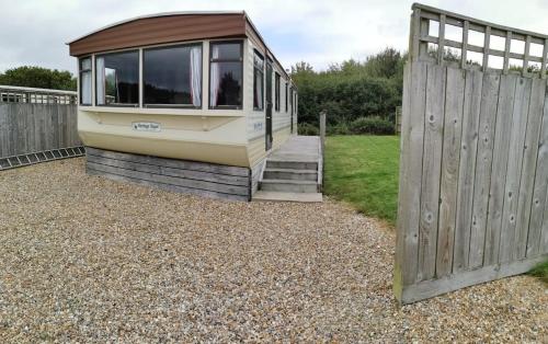a small house with a door and a fence at Culver in Newport