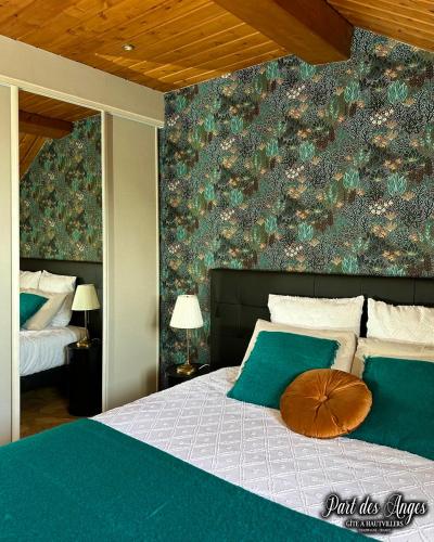 a bedroom with a large bed with a green wall at Part des Anges - Gîte Hautvillers in Hautvillers