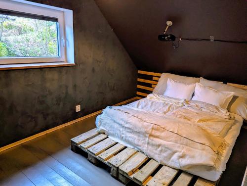 a bed in a room with a window at Fjord View Cabin Near Bergen & Nature in Grottveit