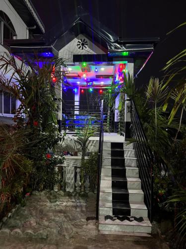 a house with colorful lights on the front of it at Apex guest facility in Buea