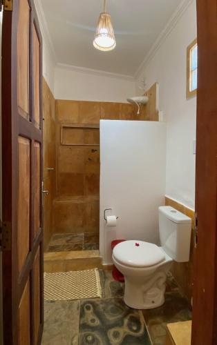 a bathroom with a toilet and a shower at Pousada da Renata in Jericoacoara