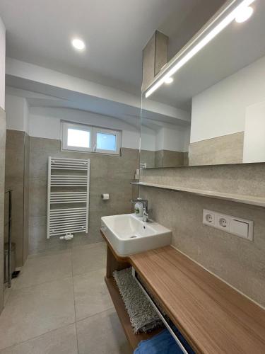 a bathroom with a white sink and a counter at Haus Gnädinger in Hagnau