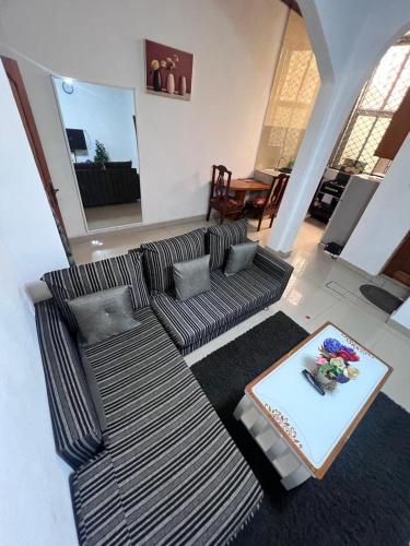 a living room with a couch and a table at Apex guest facility in Buea