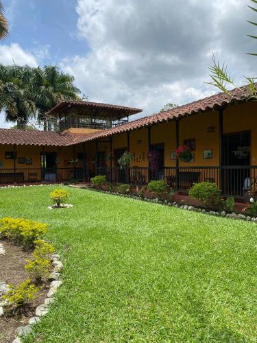 a building with a lawn in front of it at Finca chalet El Robledal in Pueblo Tapao