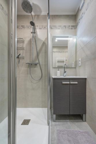 une salle de bain avec douche et lavabo dans l'établissement Magnifique T3 wifi, garage et climatisation à 5 min de la plage, à Beaulieu-sur-Mer