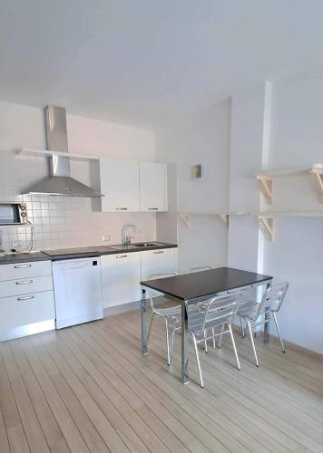 a kitchen with a table and chairs in a room at Villa Treccani Apartments in Malcesine