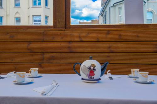 a table with a tea pot on top of it at OYO Pier Hotel in Clacton-on-Sea