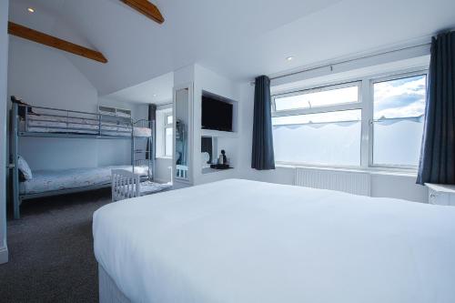 a bedroom with a bed and a large window at OYO Pier Hotel in Clacton-on-Sea