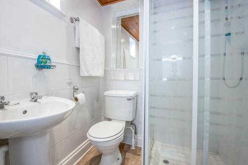 a bathroom with a toilet and a sink and a shower at OYO Pier Hotel in Clacton-on-Sea