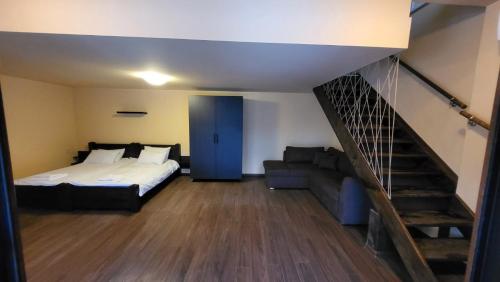 a bedroom with a bed and a stair case at Къща за гости Seltse Villa in Seltse