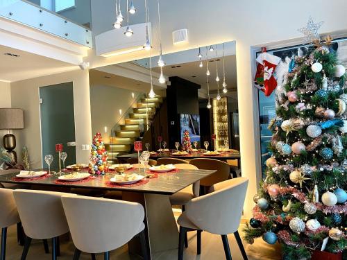 a christmas tree in a restaurant with a table and chairs at Magnolia House with Indoor Swimming Pool and Sauna in Tallinn