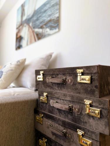 two old suitcases are sitting next to a bed at Magnolia House with Indoor Swimming Pool and Sauna in Tallinn